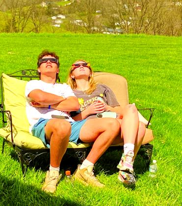 Matteo Romeo of Falmouth and his girlfriend, Tori Cravens of Cincinnati, watch the eclipse from the Romeo family farm on Liberty Ridge. Photo by Patricia Romeo.