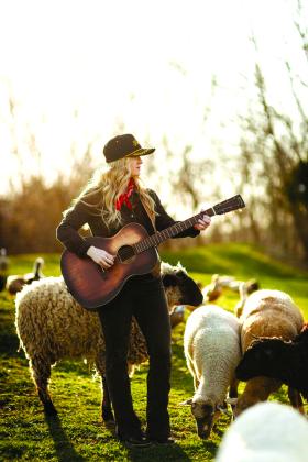 Singer-songwriter Sami Riggs, now of Dry Ridge but who grew up in Butler, salutes her Pendleton County roots with a photoshoot at BlackSheep Farmstead in Falmouth for the upcoming release of her single, “Black Sheep.” Photo by Kandice Smith Photography.