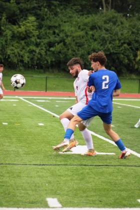 Defender Tristan Mitchell holds off a Scott player during their match on August 15.