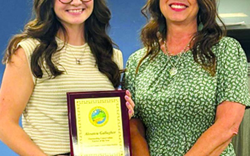 The Conservation Teacher of the Year award is presented to Aissatou Gallagher, left, by Soil Conservation District representative Maxie Kordes.