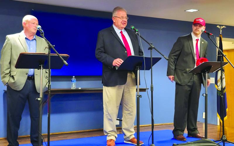 Rick Mineer, left, and Sebastian Ernst, right, listen as Anthony Strong answers a question during the Pendleton County Farm Bureau’s Measure the Candidates event April 8 at the Pendleton County Cooperative Extension Office. The three men, along with Jimmy Poynter, are vying for the Republican Party nomination for county judge executive on the May 19 primary election. Since no one filed for the Democratic nomination, the winner of the primary is virtually assured of winning the office in the November general