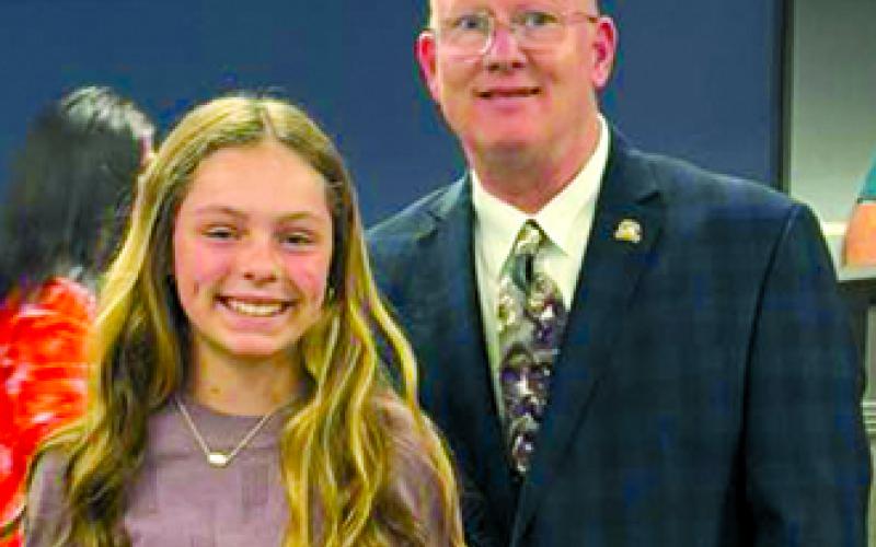 Pendleton County Soil Conservation District countywide writing contest winner Remmi Prince poses with Rep. Mark Hart. Not pictured are second place finisher Daniel Drury and third place finisher Ellie Fultz.