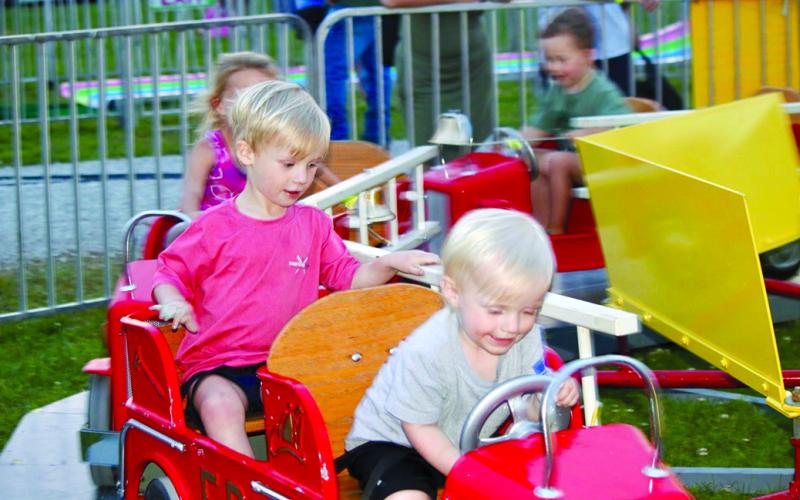 Graham, left, and Brooks Fisher take a drive in the carnival portion of the Pendleton County Youth Fair.