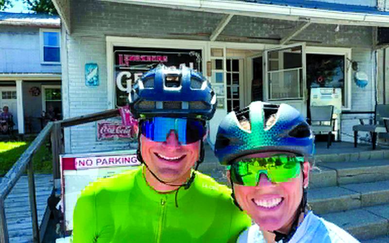 Pendleton County native Natalie Kelsch Stewart and her husband, AJ, take a breather at the Lenoxburg Store during a 100-mile bike ride June 20. The couple are training for the Ironman Lake Placid on July 19 in Lake Placid, New York.
