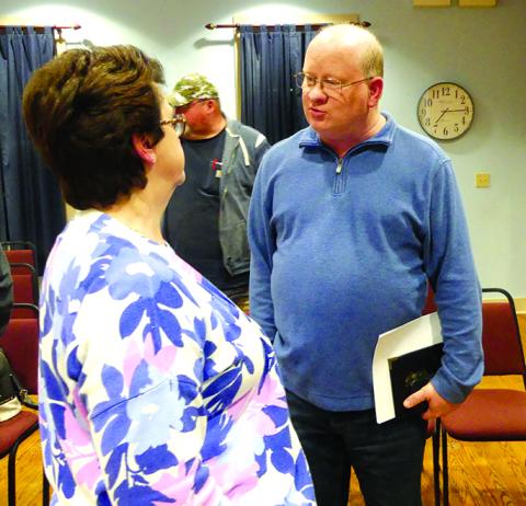 Newly-hired police chief Marty Hart speaks with City Clerk Ramona Williams after the meeting that approved his hiring. Hart will begin as chief March 1.