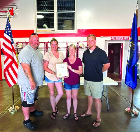 David Marquardt’s family--son Ryan, daughter Kymberleigh, wife Cathy accept the proclamation from Falmouth Mayor Sebastian Ernst.